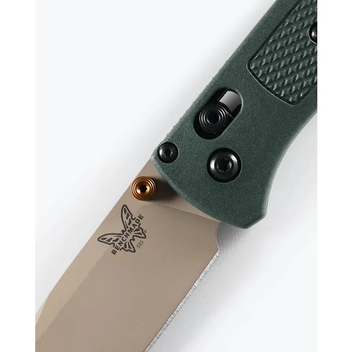 Folded utility knife with green textured handle and a partially exposed blade marked Benchmade on the blade edge