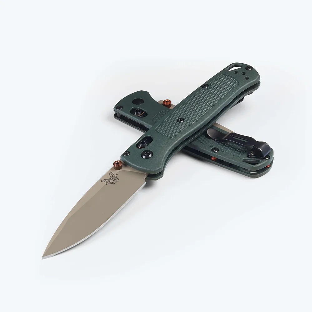Green folding knife with a tan drop-point blade, opened on a white background, showing textured handle grip.