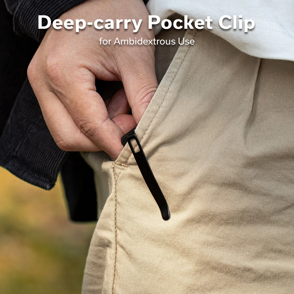 Close-up of a hand tucking a slim black pocket clip into a khaki pant pocket, illustrating a deep-carry pocket clip design for ambidextrous use.