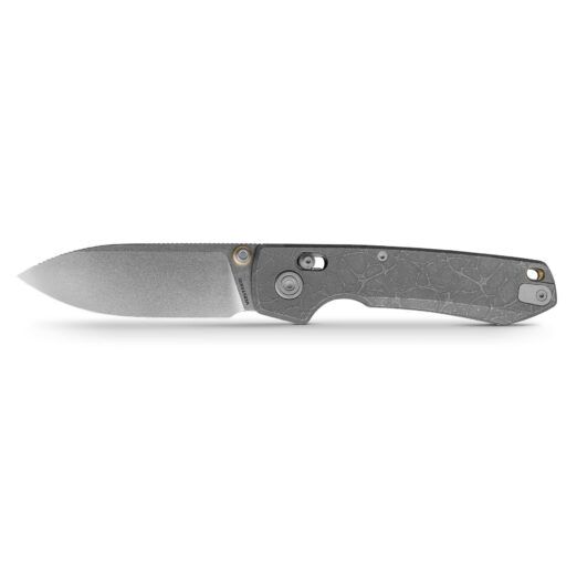 Folding knife partially visible along the bottom edge with a textured gray handle and blade point extending leftward against a white background.