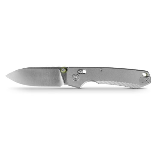 Close-up of a silver folding knife blade with pivot screw and a small green accent near the handle.