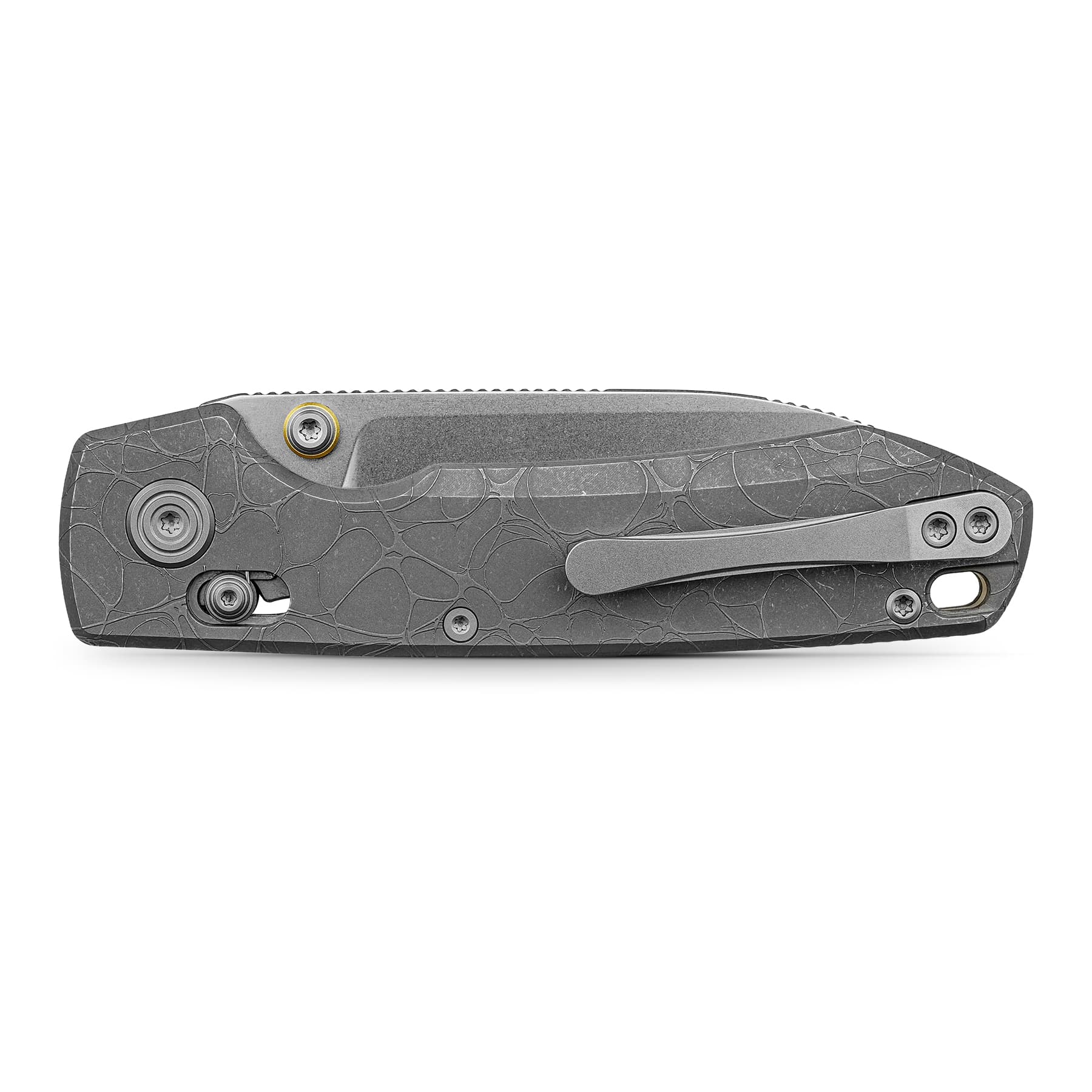 Close-up of a gray textured folding knife handle with visible screws and a pocket clip edge at the bottom of the image.