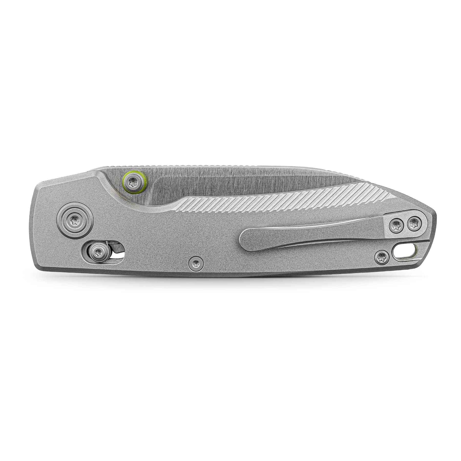 Close-up of a silver folding knife handle with textured grip and visible screws, the pivot ring highlighted in green.