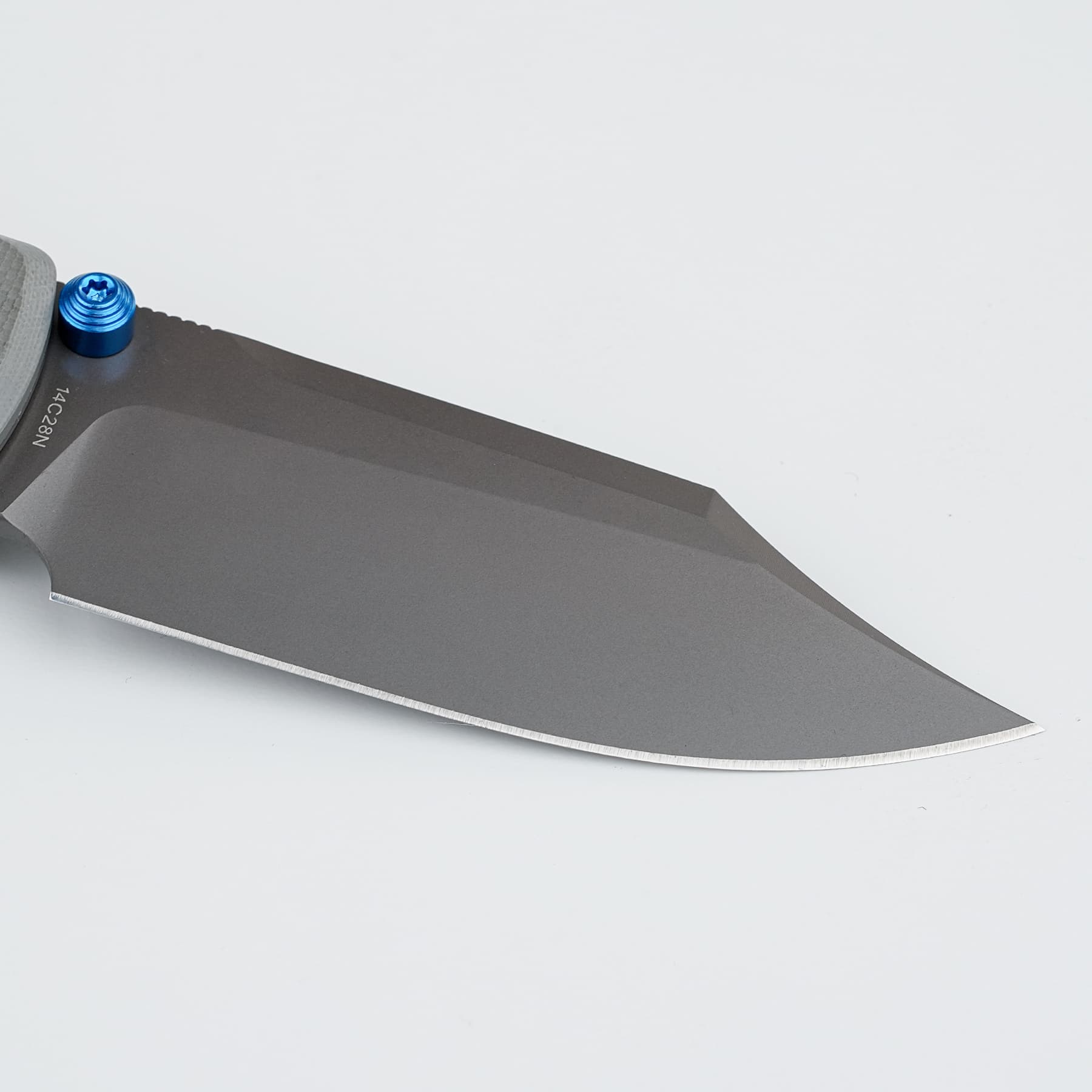 Close-up of a gray blade with a blue pivot screw against a white background