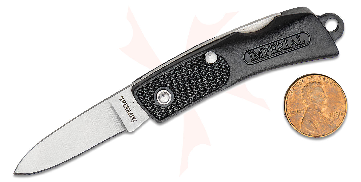 Foldable pocket knife with black textured handle labeled Imperial, blade extended, beside a penny for scale.